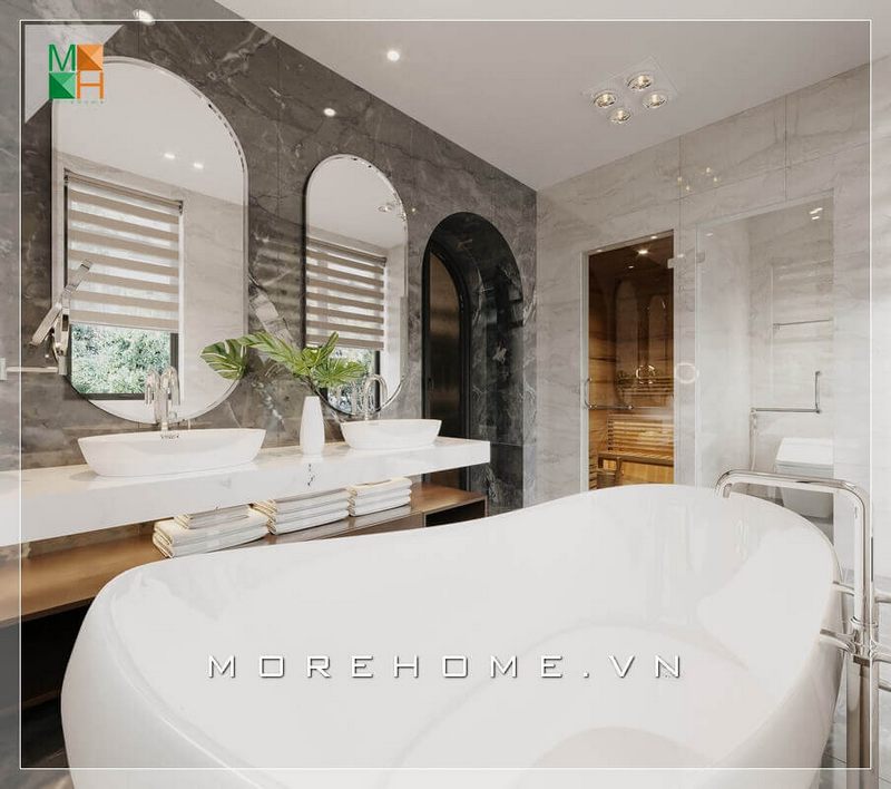 Mẫu thiết kế phòng tắm có diện tích rộng, với bồn lavabo đôi ốp đá nhân tạo màu trắng cao cấp kết hợp gương đôi sang trọng nổi bật trên nền tường phòng ốp đá đen vân trắng